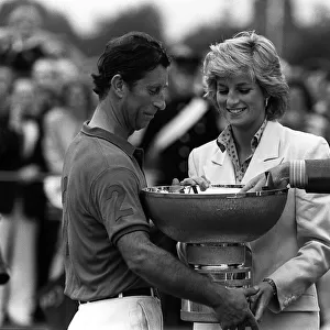 PRINCE CHARLES AND PRINCESS DIANA. CHARLES BEING PRESENTED WITH A TROPHY FOR WINNING SOME
