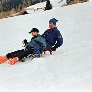 Prince Charles on a sledge with Prince Harry while on holiday in Klosters, Switzerland