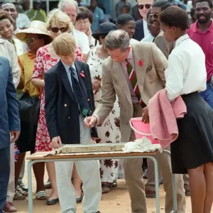 Prince Charles and his son Prince Harry visit the village of Dukuduku in South Africa