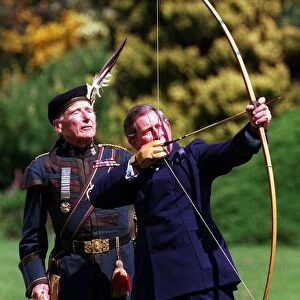 Prince Charles trys his hand at archery with the Royal Company of Archers