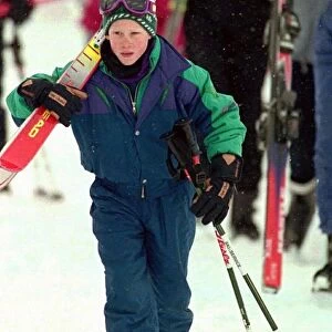 PRINCE HARRY STANDING IN THE SNOW HOLDING HIS SKIS DURING HIS HOLIDAY IN LECH