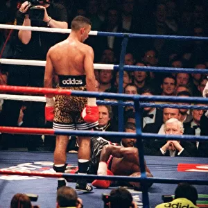 Prince Naseem Hamed looks down at Tom Boom Boom Johnson after knocking him to the canvas