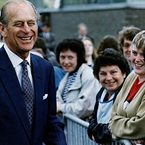 Prince Philip, Duke of Edinburgh, smiles as he talks to local woman on a walkabout in