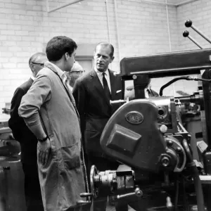Prince Philip, Duke of Edinburgh talks to 20-year-old Russell Thomas as he operates a Prince Philip, Duke of Edinburgh talks to 20-year-old Russell Thomas as he operates a