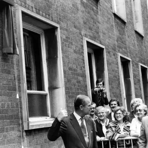 Black and white print of Prince Philip unveiling a plaque