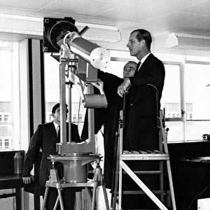 Prince Philip visiting Wales. Mr D A Richards explains the camera for the optical