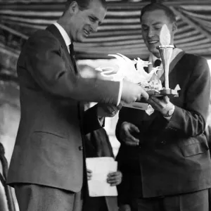 Prince Philip visiting Wales. A scroll and electric lamp stand is presented to the Duke