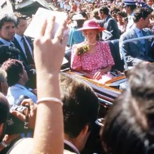 The Prince and Princess of Wales in a car driving through crowds of well wishers in front The Prince and Princess of Wales in a car driving through crowds of well wishers in front