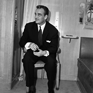 Prince Rainier of Monaco in his suite aboard the ile de France. 22nd March 1956