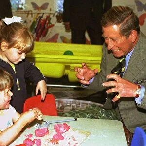 The Prince of Wales jokes with children Lauren Davies, left, aged two