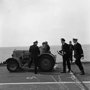 The Prince of Wales is taken for a trip round the flight deck of HMS Eagle in a tractor The Prince of Wales is taken for a trip round the flight deck of HMS Eagle in a tractor