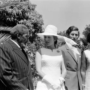 Princess Anne and Prince Charles watch a traditional dance of welcome alongside