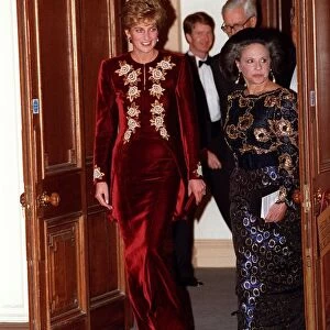 Princess Diana arrives for the Nutcracker ballet. She is wearing a burgundy velvet