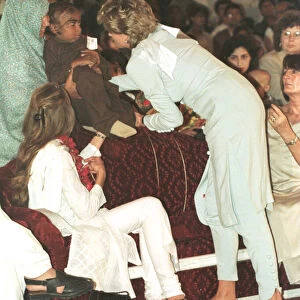 Princess Diana cradles a sick child during a visit to the Shaukat Khanum Memorial
