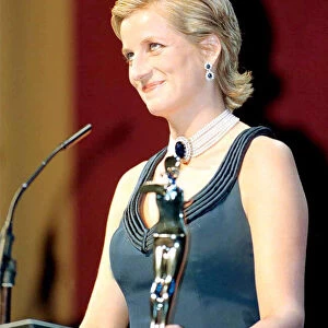Princess Diana gels her hair and a blue evening dress with pearl necklace as she