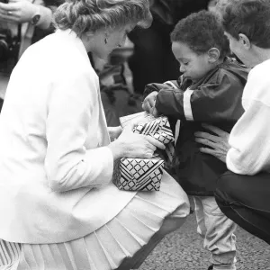 Princess Diana handing out a few surprise gifts to children at the start of the 1988 Princess Diana handing out a few surprise gifts to children at the start of the 1988