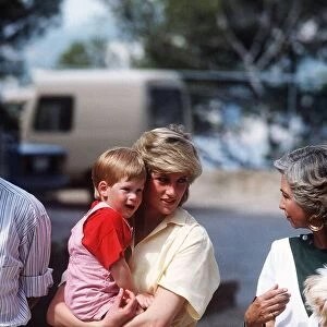 Princess Diana holds her young son Prince Harry on holiday in Majorca, Spain