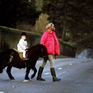 Princess Diana leading a young Prince Harry and his shetland pony across the road at