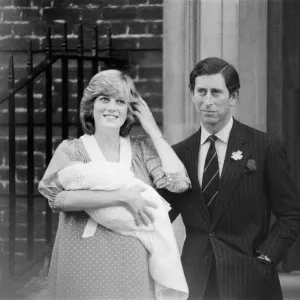 Princess Diana, the Princess of Wales holds her newborn baby son William with husband