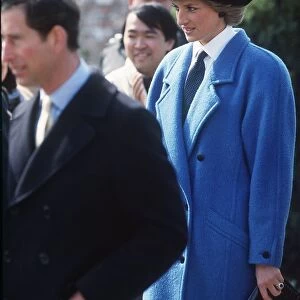Princess Diana, Princess of Wales, wearing a blue coat, with husband Prince Charles on a
