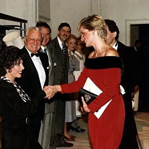 Princess Diana shakes hands with actress Joan Collins after a charity performance of
