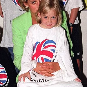 Princess Diana sitting with Jessica Waugh on her lap during a visit to a children