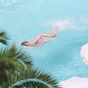 Princess Diana swimming in the pool while on holiday at Richard Branson