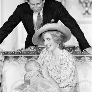 Princess Diana, watched by husband prince Charles, holds her son Prince William in her