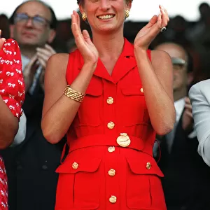 Princess Diana, wearing red sleveless dress, applauds the play at the Wimbledon mens