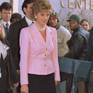 Princess Diana wears pink jacket and black skirt during a visit to Harlem