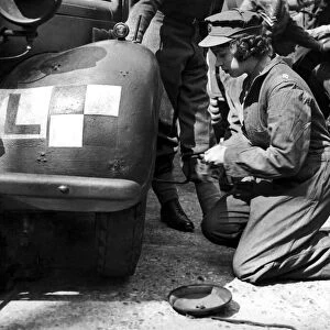 Princess Elizabeth learning basic car maintenance as a Second Subaltern in the A. T