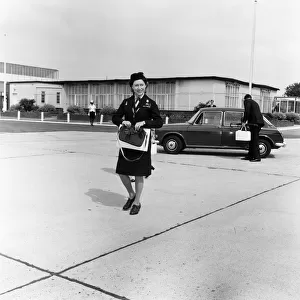 Princess Margaret in Girl Guide uniform leaving Heathrow Airport to fly to Shawbury