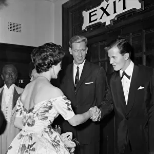 Princess Margaret shakes hands with Pat Boone, in the middle is ventriloquist Ron Parry