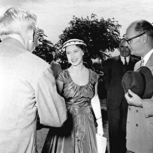 Princess Margaret smiling and shaking hands February 1955 during a visit to Africa