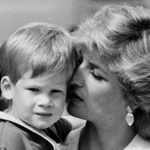 Princess of Wales holds her young son Prince Harry on holiday in Majorca, Spain