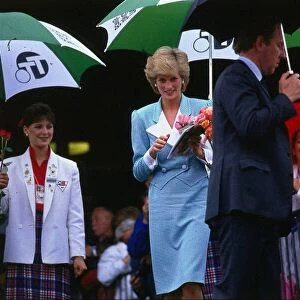 Princesss Diana, Princess of Wales, sheltering from the rain during a walkabout in