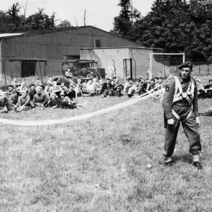 Print of a Paratrooper Demonstrating Equipment Fitting Print of a Paratrooper Demonstrating Equipment Fitting