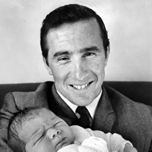 Proud father racing driver Jackie Stewart seen here holding his son Paul Evan