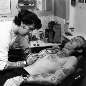 Print of a Southsea man with an Elvis portrait tattoo on his chest