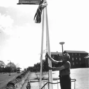 Publican Fred Howe lowers the Union Jack outside his hostel Publican Fred Howe lowers the Union Jack outside his hostel