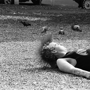 A punk relaxing in midday sun in Chelseas Kings Road. 20th August 1984