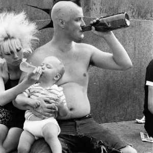 Punk rocker Jock and his young son William enjoying the warm weather in Trafalgar Square Punk rocker Jock and his young son William enjoying the warm weather in Trafalgar Square