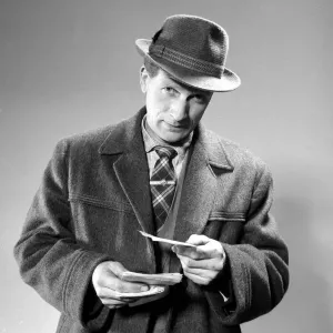 A punter holding his betting slips before placing his bet March 1963