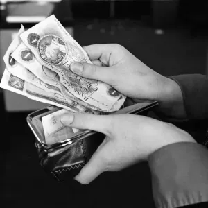 A purse filled with pound notes. 31st January 1977 A purse filled with pound notes. 31st January 1977