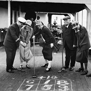 The Purser of the Minnekhada shows our prizewinners how to play Deck Golf