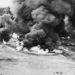Pursuing a scorched earth'policy the British forces in Malaya have burnt