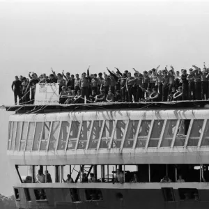 QE2 returns home to Southampton. Union Jacks are festooned on cars, draped on shoulders QE2 returns home to Southampton. Union Jacks are festooned on cars, draped on shoulders