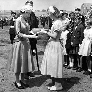Queen Elizabeth II accepts a gilf of pottery made from Holy Island clay from Margaret