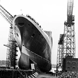 The Queen Elizabeth II gathers speed as the stern enters the water after the launching
