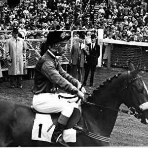 Queen Elizabeth II, with Lord Sefton, watches her horse Garter Lady go out for